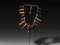 A thai palad khik phallic necklace with 16 amulets, h 26 cm