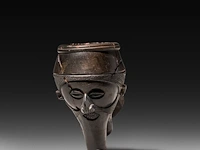 A very rare black clay yaka pipe, decorated with a man's head with a phallus-shaped beard, d.r. congo 6 cm. (2.35 in.)