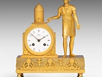 An empire gilt bronze mantle clock with a beekeeper on top, ca. 1830 29.5 x 23 cm. (11.60 x 9.06 in.)
