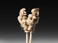 An erotic ivory glove stretcher with the figures of punch and judy having intercourse, english, 19thc, h 24 cm - w 5 cm - 79g (+)
