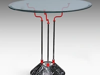 An italian design occasional table with a marble base and a glass top 61 x 65 cm. (24.01 x 25.58 in.)