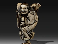 An ivory netsuke of gama sennin holding a peach branch, his three-legged toad on his shoulder, signed yoshinaga, edo period (late 18thc), h 6,5 cm - w 4 cm - d 2,5 cm - weight 32g (+)