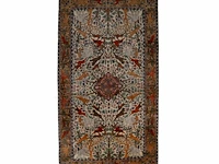 An oriental woollen rug, decorated with various animals 275 x 142 cm. (108.26 x 55.90 in.)