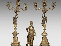 Anatole guillot (1865-1911), a neoclassical gilt bronze sculpture of diana and her hunting dog, accompanied by a pair of matching candelabra diana: 34 cm. (13.39 in.), the candelabra: 65 cm. (25.58 in.)