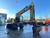 Caterpillar - 2014 - m313d - banden graafmachine - afbeelding 23 van  64