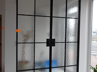 Dubbele smeedwerken deur