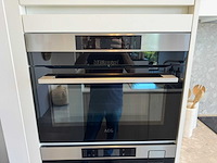 Exclusieve designkeuken met neolith keramisch werkblad, kookeiland en aeg-inbouwtoestellen - afbeelding 7 van  20