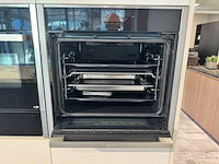 Exclusieve showroomkeuken met luxe keramisch monobloc-eiland, hoogwaardige neff-toestellen en novy dampkap - afbeelding 17 van  23