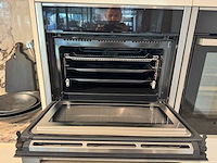 Exclusieve showroomkeuken met luxe keramisch monobloc-eiland, hoogwaardige neff-toestellen en novy dampkap - afbeelding 10 van  23