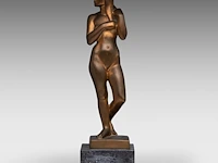 Fernand debonnaires (1907-1997), female nude standing, patinated bronze on a bluestone base the bronze: 38.5 cm. (15.16 in.), including the base: 44.5 cm. (17.51 in.)