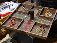 Houten speelbord met pionnnen op lederen bijzetpoef - afbeelding 1 van  3