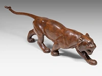 Louis emile morlet (xx), a wooden art deco sculpture of a prowling lioness 29 x 112 cm. (11.41 x 44.09 in.)