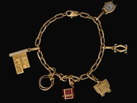 Santos de cartier charm bracelet in 18ct yellow gold, with diamond charms, weight: 46,3 g (+)