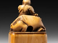 Two japanese ivory netsuke, one of a sitting dog, the other of roshi and an ox, both edo period, h 3,3 cm - w 3 cm - d 1,8 cm - 10g / h 4,3 cm - 27,6g (+) - afbeelding 8 van  13