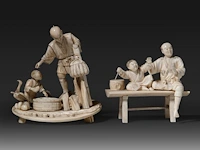 Two japanese ivory okimono of fathers with their sons, meiji period (1868-1912): one of a farmer and his son gathering eggs, with a goose and baskets, on an oval base (signed); the other of a father seated on a bench wit
