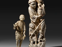 Two japanese walrus ivory okimono, one of a farmer with his crop, the other of a fisherman with his two children, meiji/taisho period (first half of the 20thc), h 17 cm / h 25,5 cm (*)