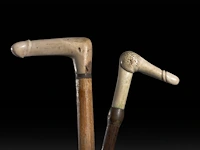 Two walking sticks with carved bone phallic endings, late 19thc